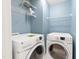 Laundry room featuring a full size washer and dryer and overhead storage shelves at 2420 Sapphire Valley Dr, Raleigh, NC 27604