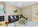 Spacious living room with a grey sectional sofa, decorated fireplace, and stylish decor at 2420 Sapphire Valley Dr, Raleigh, NC 27604
