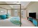 Bright main bedroom featuring neutral walls, a decorative bed with turquoise accents, and a modern entertainment center at 2420 Sapphire Valley Dr, Raleigh, NC 27604
