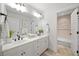 Bright bathroom featuring double vanity, framed mirror, and shower at 2507 Mayview Rd, Raleigh, NC 27607