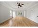 Inviting bedroom with hardwood floors, a ceiling fan, light walls, and a large window at 2507 Mayview Rd, Raleigh, NC 27607