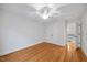 Bright bedroom with hardwood floors, ceiling fan, and closet at 2507 Mayview Rd, Raleigh, NC 27607