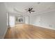 Large bedroom with light walls, a ceiling fan, hardwood floors, and a large window at 2507 Mayview Rd, Raleigh, NC 27607