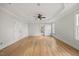 Bright and airy bedroom with hardwood flooring, a ceiling fan, and multiple windows at 2507 Mayview Rd, Raleigh, NC 27607