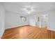 Bedroom featuring hardwood floors, a window, light walls, and an ensuite bath at 2507 Mayview Rd, Raleigh, NC 27607