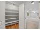 Large walk-in closet with built-in shelving and hardwood floors at 2507 Mayview Rd, Raleigh, NC 27607