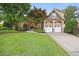 Charming home with a well-manicured lawn, a two-car garage, and stone and siding accents at 2507 Mayview Rd, Raleigh, NC 27607