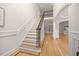 Elegant foyer featuring hardwood floors, staircase with iron railing, and an open floor plan at 2507 Mayview Rd, Raleigh, NC 27607