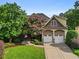 Charming front exterior with manicured lawn, mature trees, and a two-car garage at 2507 Mayview Rd, Raleigh, NC 27607