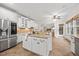 Bright kitchen features white cabinetry, granite countertops, a kitchen island, and stainless steel appliances at 2507 Mayview Rd, Raleigh, NC 27607