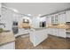 Bright kitchen features white cabinetry, granite countertops, backsplash, and stainless steel appliances at 2507 Mayview Rd, Raleigh, NC 27607