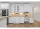 Bright kitchen featuring white cabinetry, granite countertops, tile floors, and stainless steel refrigerator at 2507 Mayview Rd, Raleigh, NC 27607