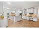Spacious kitchen features white cabinetry, tiled floors, granite countertops, and a center island with breakfast bar seating at 2507 Mayview Rd, Raleigh, NC 27607