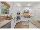 Bright kitchen features white cabinetry, granite countertops, stainless steel appliances, and tile floors at 2507 Mayview Rd, Raleigh, NC 27607