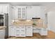 Bright kitchen boasts white cabinets, stainless appliances, and granite countertops with a desk area for convenience at 2507 Mayview Rd, Raleigh, NC 27607