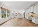 Bright kitchen features white cabinets, an island, granite countertops and stainless steel appliances at 2507 Mayview Rd, Raleigh, NC 27607