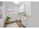 Laundry room featuring white cabinetry, sink, and a window for natural light at 2507 Mayview Rd, Raleigh, NC 27607
