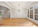 Spacious living room with hardwood floors, wainscoting, and ample natural light from large windows at 2507 Mayview Rd, Raleigh, NC 27607