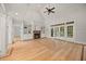 Bright living room featuring hardwood floors, fireplace, built-in shelving, and large glass doors for natural light at 2507 Mayview Rd, Raleigh, NC 27607
