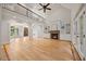 Open living room with hardwood floors, a fireplace, built-in shelves, and large glass doors leading to the outdoors at 2507 Mayview Rd, Raleigh, NC 27607