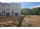 New construction townhouse with visible framing, windows, and unfinished landscaping awaiting personalization at 252 Grand Silo Rd, Garner, NC 27603