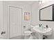 This bathroom has a stylish pedestal sink and a classic black and white tile floor at 2525 Buxton Ct, Chapel Hill, NC 27514