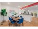 Dining room with wood floors, modern lighting, and an adjacent kitchen area at 2525 Buxton Ct, Chapel Hill, NC 27514