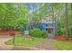 Charming two-story home with a beautiful blue exterior, inviting front yard, and lush green trees at 2525 Buxton Ct, Chapel Hill, NC 27514
