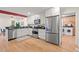 Well-equipped kitchen with stainless steel appliances, white cabinets, and an adjacent laundry room at 2525 Buxton Ct, Chapel Hill, NC 27514