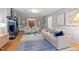 Open living room featuring hardwood floors, a comfortable sofa, a fireplace, and built-in shelving at 2525 Buxton Ct, Chapel Hill, NC 27514