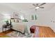 Cozy primary bedroom features a ceiling fan, hardwood floors, and a large window at 2525 Buxton Ct, Chapel Hill, NC 27514