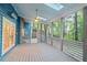 Beautiful screened porch with a ceiling fan, skylights, and view of the lush backyard at 2525 Buxton Ct, Chapel Hill, NC 27514