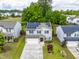 Aerial view of a two-story home with solar panels, a well-maintained lawn, and mature trees at 2622 Perthshire Ln, Fuquay Varina, NC 27526