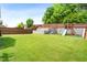 Wide view of the well-maintained backyard showcasing the playground, fence, and retaining walls at 2622 Perthshire Ln, Fuquay Varina, NC 27526