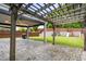 Backyard featuring stamped concrete patio, wood pergola, covered patio with fan, and a playground at 2622 Perthshire Ln, Fuquay Varina, NC 27526