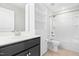 Bathroom with a bathtub and shower, white toilet, and a vanity with a black cabinet at 2622 Perthshire Ln, Fuquay Varina, NC 27526