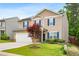 Charming two-story home featuring blue shutters, a well-maintained lawn, and a two car garage at 2622 Perthshire Ln, Fuquay Varina, NC 27526