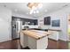 Bright kitchen features stainless steel appliances, a butcher block island, and dark cabinets at 2622 Perthshire Ln, Fuquay Varina, NC 27526