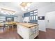 Open concept kitchen features a large island, hardwood floors, and modern lighting at 2622 Perthshire Ln, Fuquay Varina, NC 27526