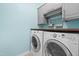Laundry room with washer and dryer, cabinets above, and a wooden folding table at 2622 Perthshire Ln, Fuquay Varina, NC 27526
