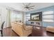 Cozy living room with a fireplace, a ceiling fan and comfortable leather seating at 2622 Perthshire Ln, Fuquay Varina, NC 27526