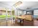 Open-concept living space featuring large windows, wood dining table, and custom built-ins at 2622 Perthshire Ln, Fuquay Varina, NC 27526