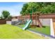 Backyard play area featuring a playground set with a slide and climbing wall, sitting on green astroturf at 2622 Perthshire Ln, Fuquay Varina, NC 27526