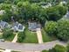 Expansive aerial view of a neighborhood with mature trees, well-maintained homes, and winding roads at 2721 Dahlgreen Rd, Raleigh, NC 27615