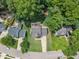 A bird's-eye view of a house with mature trees, highlighting the backyard, driveway, and neighborhood street at 2721 Dahlgreen Rd, Raleigh, NC 27615