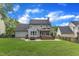 Expansive backyard features a covered patio, a well-manicured lawn, and mature trees offering shade and privacy at 2721 Dahlgreen Rd, Raleigh, NC 27615