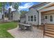 Backyard patio with stone pavers, outdoor dining set, and steps to the covered patio enhance the outdoor living experience at 2721 Dahlgreen Rd, Raleigh, NC 27615