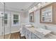 Bright bathroom featuring a double sink vanity, granite counters and tiled shower at 2721 Dahlgreen Rd, Raleigh, NC 27615