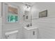 A clean and bright bathroom with shiplap walls, a modern vanity, and a framed art piece at 2721 Dahlgreen Rd, Raleigh, NC 27615