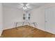 Bedroom with hardwood flooring, ceiling fan, and well-lit windows at 2721 Dahlgreen Rd, Raleigh, NC 27615